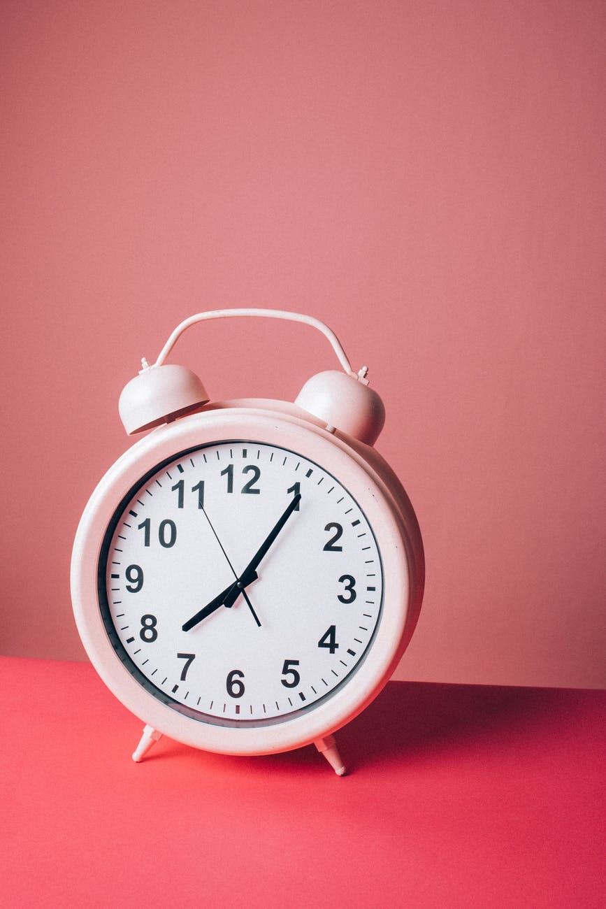 pink alarm clock - using automation can help a business grow