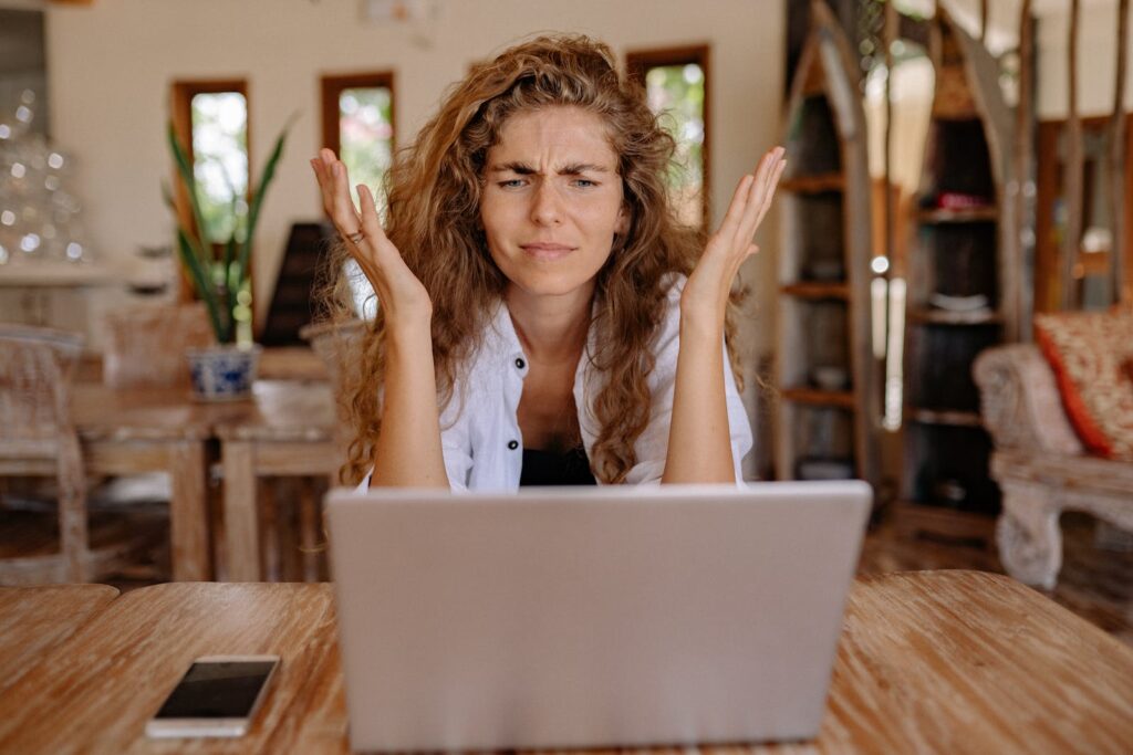 Woman Showing Frustrations while sitting in front of computer